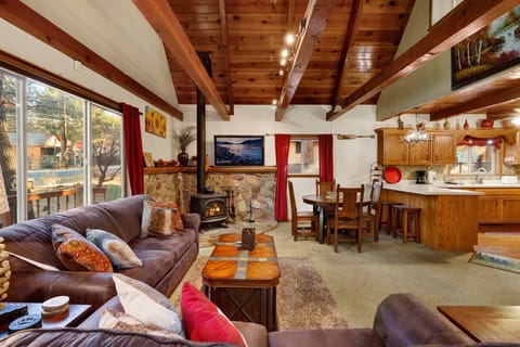 Cozy mountain living room with a fireplace, comfy seating, and smart TV perfect for relaxing evenings,