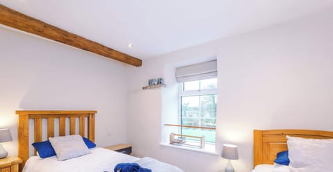 A cozy serene retreat with soft lighting, plush bedding, and a calming color palette. Thoughtful storage and tidy furnishings make it a clutter-free space, ideal for restful nights and relaxing mornings.