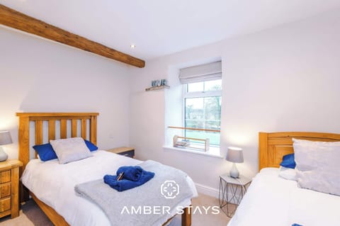 A cozy serene retreat with soft lighting, plush bedding, and a calming color palette. Thoughtful storage and tidy furnishings make it a clutter-free space, ideal for restful nights and relaxing mornings.