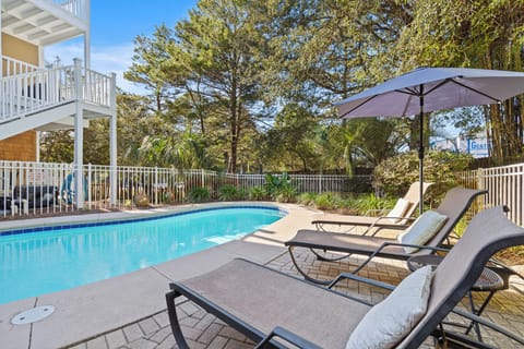 Soak up the sun on comfortable loungers by your private pool, surrounded by lush tropical landscaping and peaceful shade.