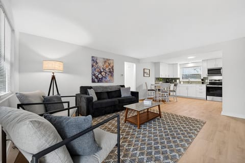 Comfortable living room with sofa bed, Smart TV, coffee table, and natural light