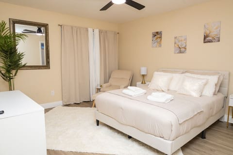Spacious Master Bedroom with Plush Bedding and Private Bathroom Access. Designed for comfort, privacy, and relaxation.