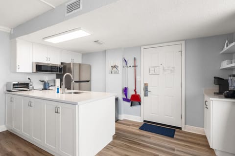 View from Living Room of Full Kitchen and Entry