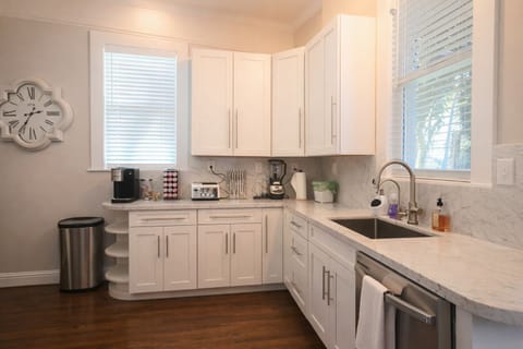 Prepare your favorite meals in our beautifully renovated, modern kitchen. Featuring sleek white cabinetry, and high-end stainless steel appliances, this space is as functional as it is stylish. With counter space and natural light.