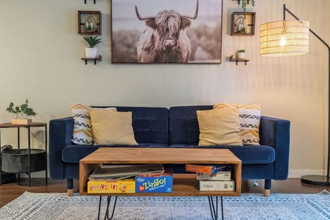 Main floor living room with a cozy couch, tons of board games, an electric fireplace, and a 55` Smart/Roku TV.