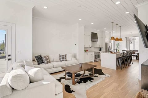 2nd Floor: Bright and open living area with cozy furnishings, a smart TV, and a private balcony.