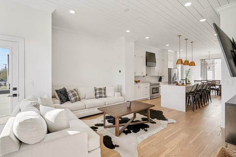 2nd Floor: Bright and open living area with cozy furnishings, a smart TV, and a private balcony.