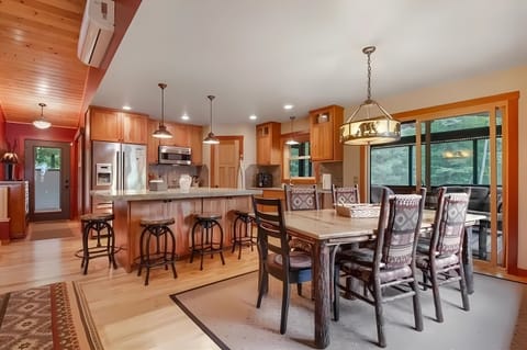 Dining Area with Kitchen Island and Walkout to the Screened Porch