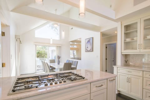 The beautiful kitchen with vaulted ceilings opens into this dining area.