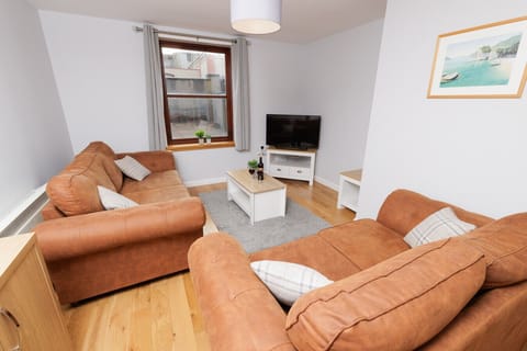 Cosy and light living area with TV and large sofas