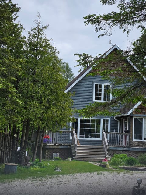 Welcome to 3 Bears Cottage – Your cozy lakeside retreat nestled among the trees, with a spacious deck for morning coffee or evening drinks.