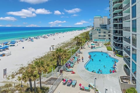 Beachfront property featuring an outdoor pool and direct beach access with pristine white sand and turquoise waters.