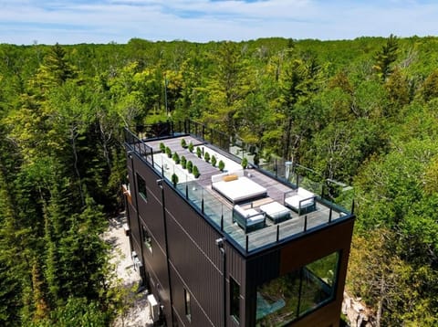 Perched high above the forest canopy, the rooftop terrace offers a private retreat for sunset cocktails, morning coffee, and unforgettable stargazing in Northern Bruce Peninsula’s Dark Sky community.