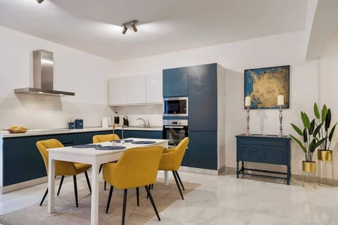 Stylish dining area set for four, ideal for shared meals or relaxed mornings before exploring Valletta.