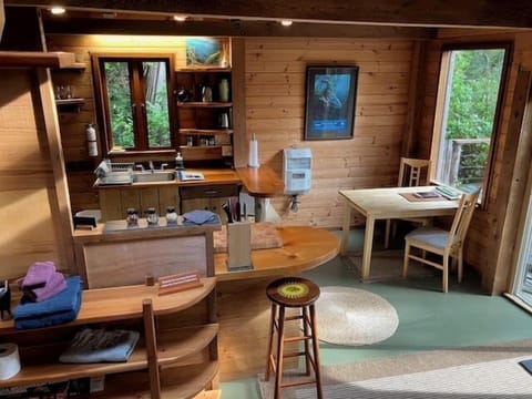 The kitchen is equipped with a oven, fridge and microwave