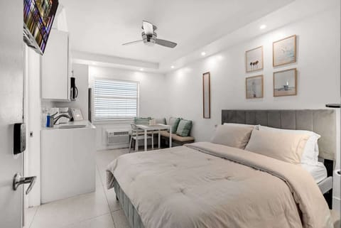 Enjoy this sun-drenched studio with a modern kitchenette and dedicated dining area. Perfect for a cozy getaway or remote work, featuring a plush queen bed and high-speed Wi-Fi. Your bright home away from home awaits!