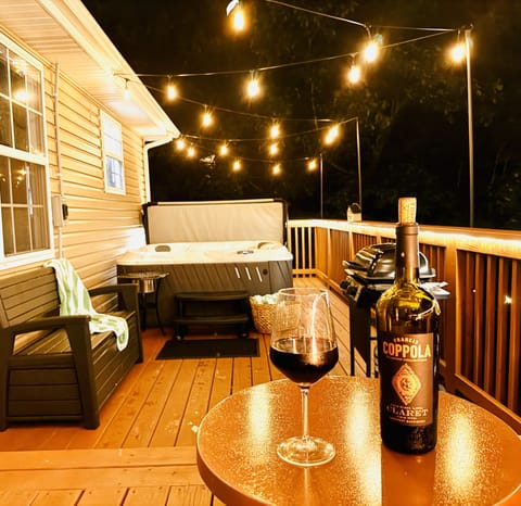Back Deck Oasis: Unwind with wine under twinkling lights and a bubbling hot tub!