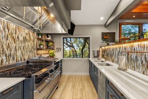 Chef's Kitchen, featuring a commercial-grade range, griddle, & double prep sinks