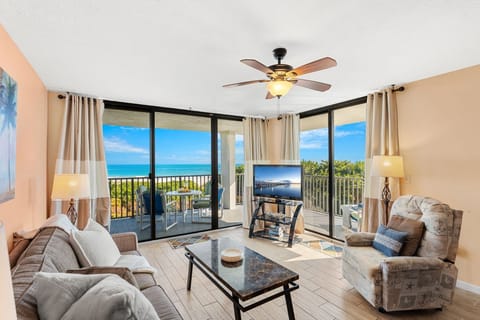 Bright & airy living room with sliding glass doors that lead to outdoor double wide balcony