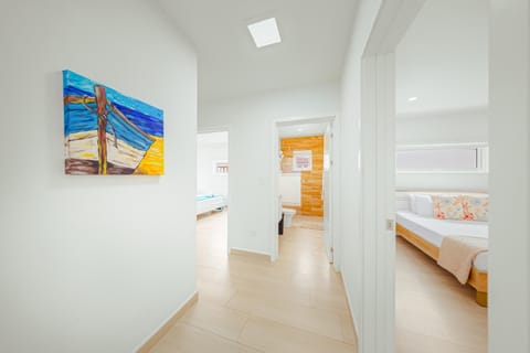 A home is only as good as the flow it creates! Our bright, sun-filled hallway isn't just a path—it's a showcase of clean, modern design and colorful island art that sets the tone for your entire stay.