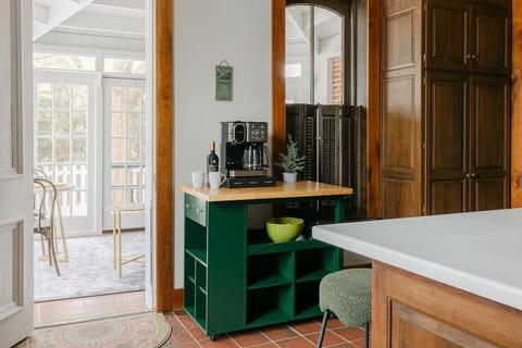 Full coffee bar with full pot and individual Keurig pods on moveable island.