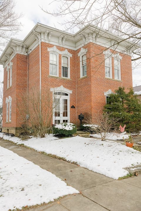 Frontal view of original Italianate Victorian architectural details preserved.