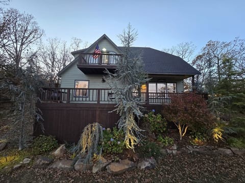 The home lights the landscaping beautifully as the sun goes down