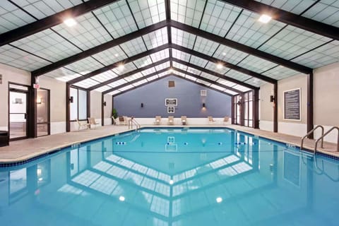 Warm indoor pool space with chairs and wide open deck