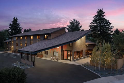 Warm sunset view with cozy lodge and glowing windows