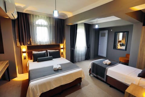 Classic Triple Room, Garden View | Desk, laptop workspace, free WiFi, bed sheets
