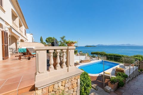 A multi-level luxury terrace featuring a private swimming pool, sun-soaked lounge areas, and panoramic ocean views.