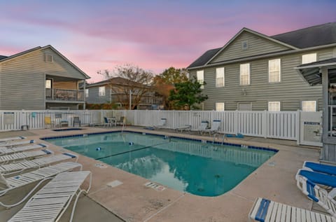 Take a cool dip in the sparkling pool after a fun day at the beach.