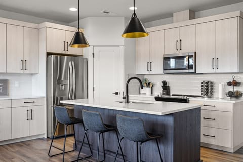 Enjoy cooking in this bright, modern kitchen with beautiful lighting.