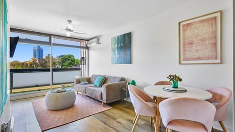 Bright open-plan living area with stunning park and city views