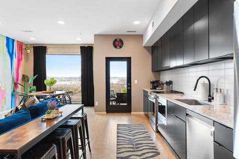 Fully equipped kitchen for all of your cooking needs! Keurig coffee machine + K-cups provided plus seating for 4 at the high-top table behind the couch.