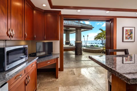 Enjoy breakfast with a view. This gourmet kitchen opens to a private lanai, where the sights and sounds of the Pacific enhance every culinary moment.