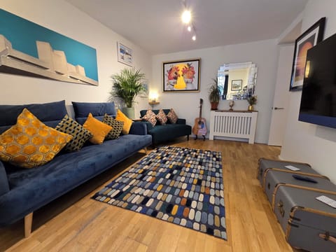 Stylish & spacious living room with contemporary art, TV with cable & streaming.