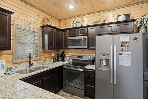 Your fully equipped cabin kitchen blends rustic wood warmth with modern convenience for memorable meals together.