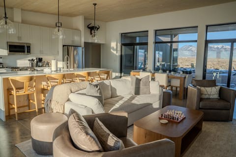 Unwind in this beautifully appointed living space where natural light streams through floor-to-ceiling windows, revealing stunning mountain vistas beyond.