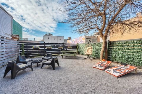 Private backyard with seating and cornhole — a rare outdoor hangout in OTR