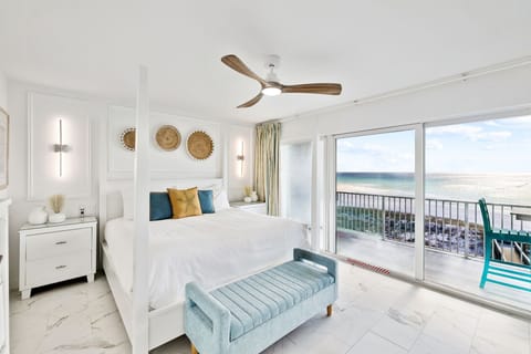 Wake up to breathtaking ocean views from your serene bedroom, where coastal breezes flow through your private balcony sanctuary.