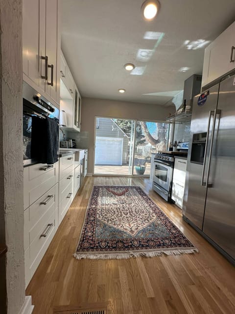 DR view into Kitchen and out back sliding glass door