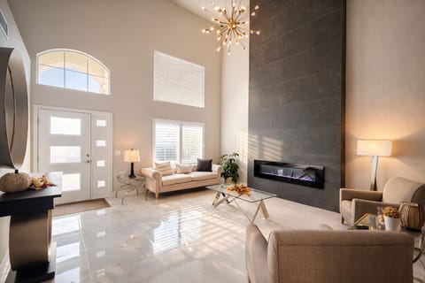 Living room with abundant natural light, soaring ceilings, and modern finishes