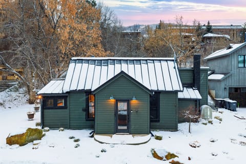 Cabin exterior in a snowy landscape.