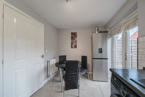 Gather for meals at the dining table with direct access outside.