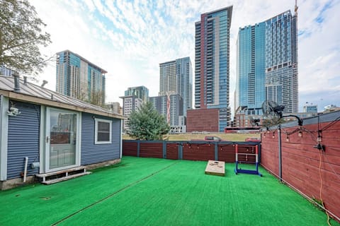 Private turf yard with skyline views and outdoor games.