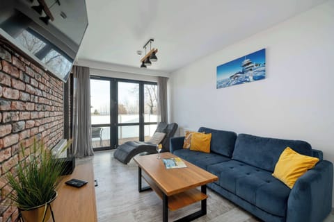 Relax in the stylish living room with a comfortable sofa and modern decor.