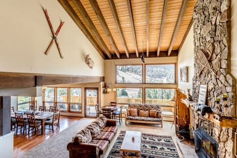 Spacious living and dining area with soaring ceilings and mountain views