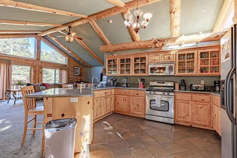 Spacious fully equipped kitchen with granite countertops and rustic wood cabinetry
