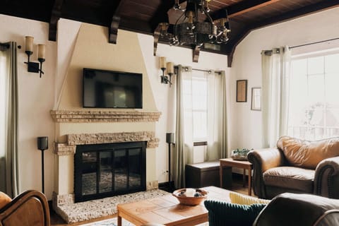 Living room with TV, Sonos speaker, and gas fireplace